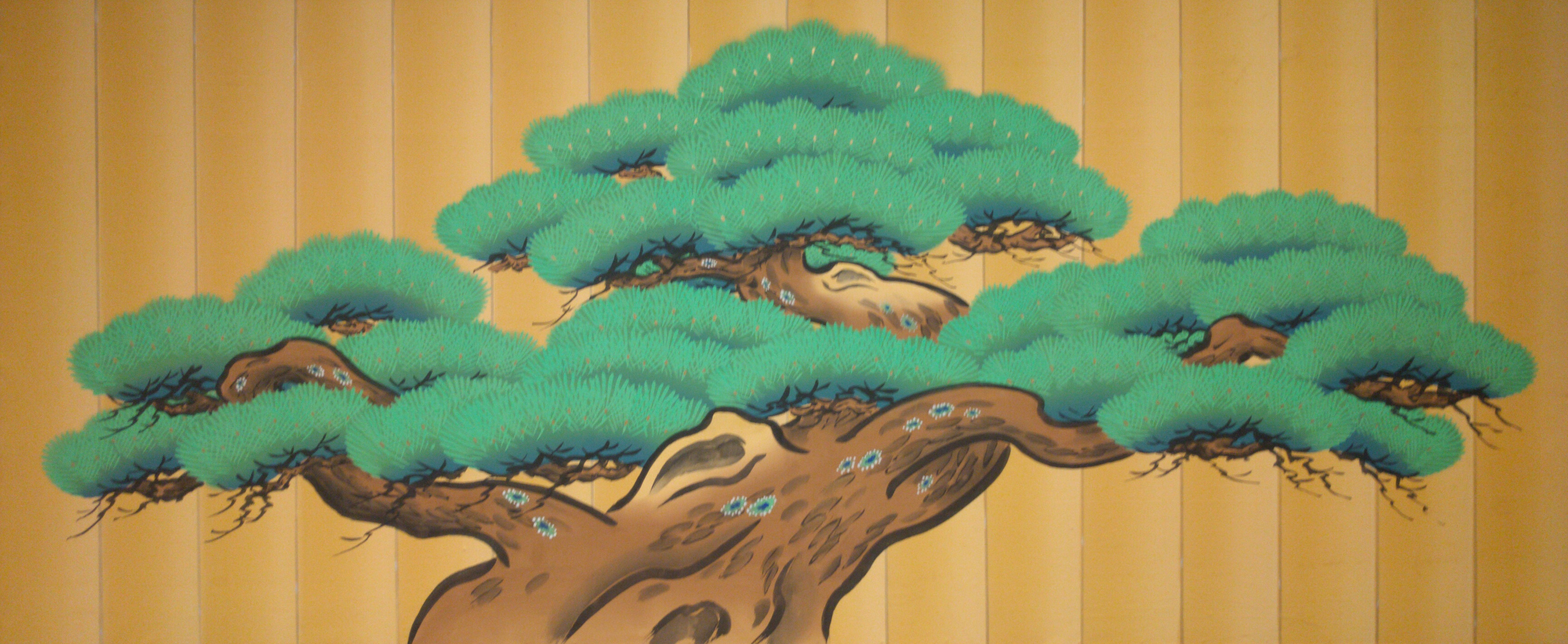 the top of a bonsai tree painted on a garage door