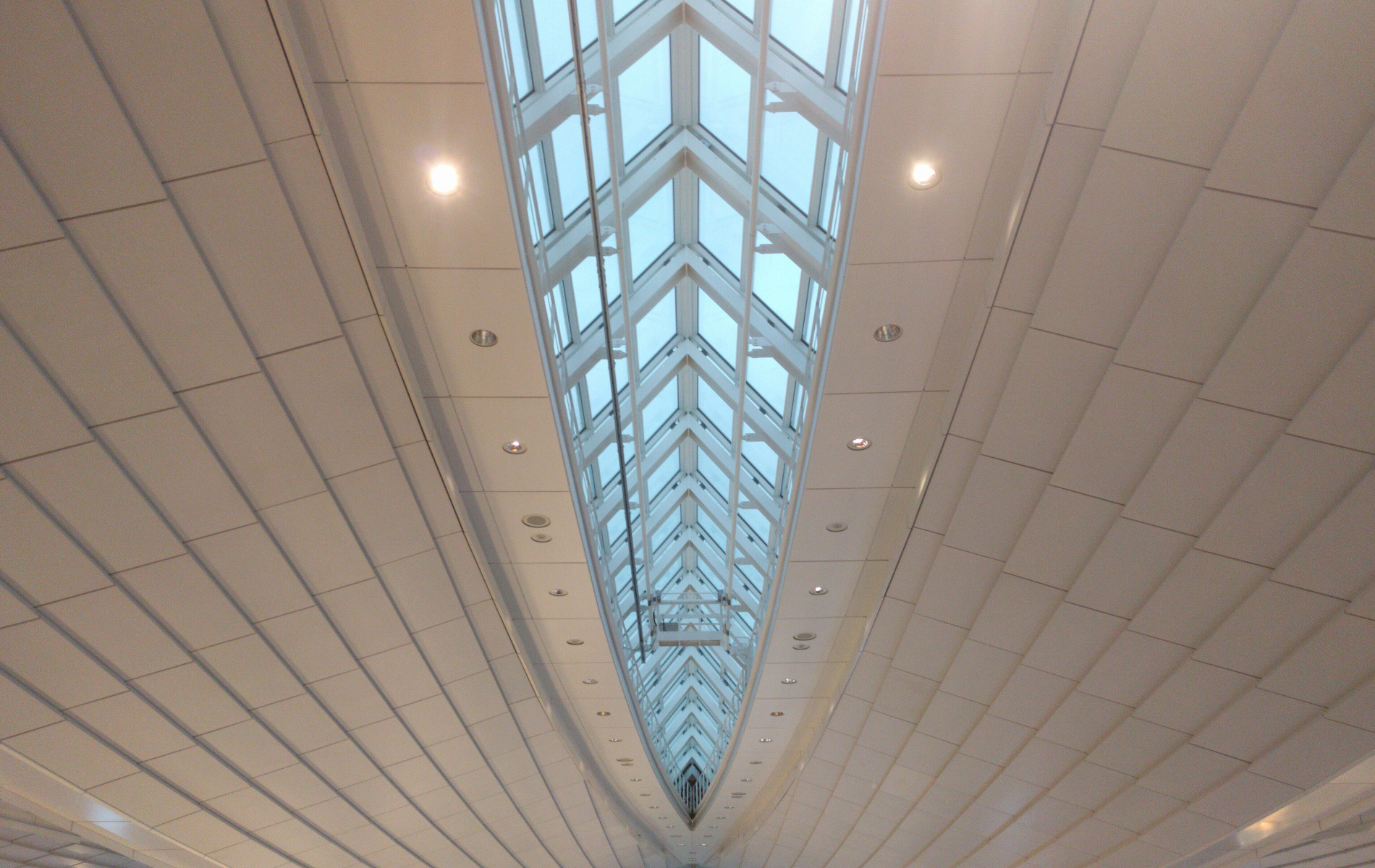 a view of a high ceiling, centred on a long sunroof in the middle